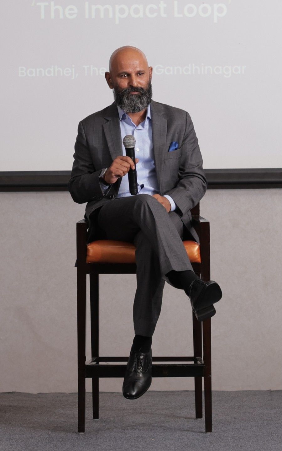 Fireside conversation beneath the Intellecap Leadership Exchange banner, Gandhinagar