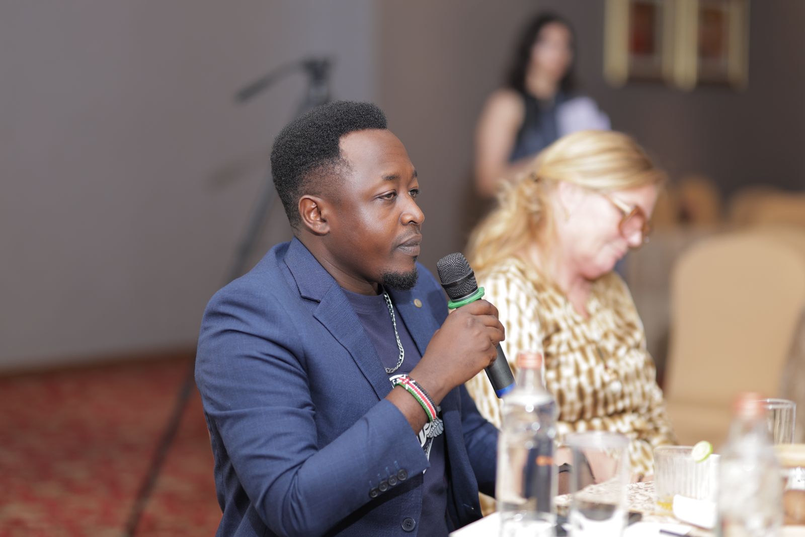 A participant taking the microphone at the Intellecap Leadership Exchange